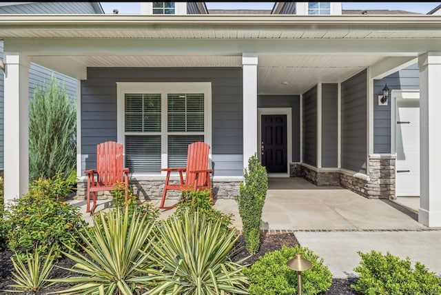 view of exterior entry with a porch