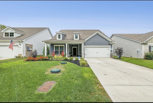 view of front of house featuring a front yard, covered porch, and a garage