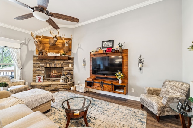 living room with ceiling fan, dark hardwood / wood-style floors, a stone fireplace, and crown molding