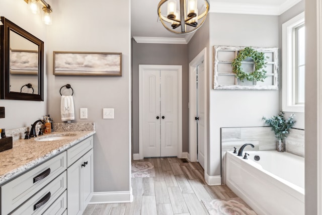 bathroom with ornamental molding, wood-type flooring, a tub, and vanity