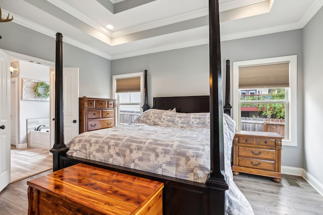 bedroom featuring ornamental molding, light hardwood / wood-style floors, and multiple windows