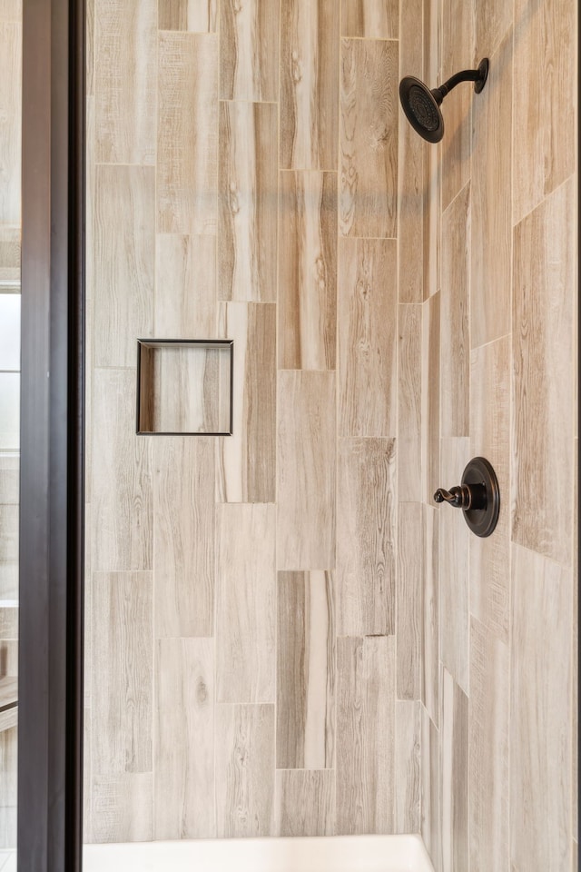 interior details with a tile shower