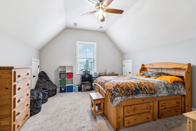 carpeted bedroom with ceiling fan and vaulted ceiling