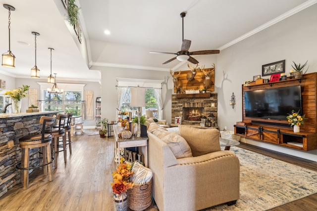 living room with hardwood / wood-style flooring, a healthy amount of sunlight, and crown molding