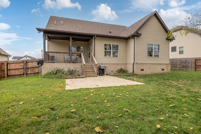 back of house with a patio and a yard