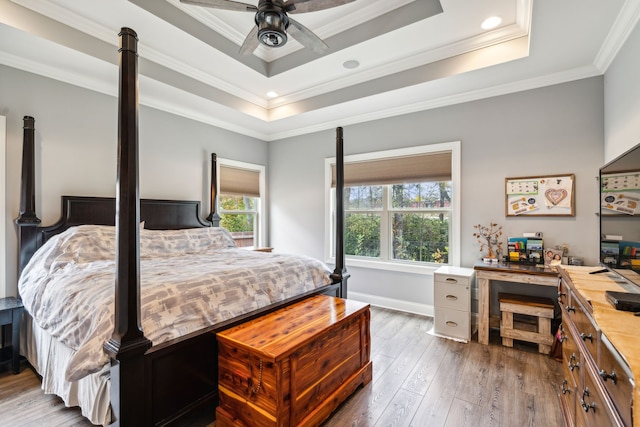 bedroom featuring ornamental molding, multiple windows, ceiling fan, and dark hardwood / wood-style floors