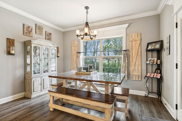 dining room with dark hardwood / wood-style floors, crown molding, and a notable chandelier