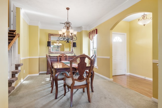 dining space featuring light hardwood / wood-style flooring and crown molding