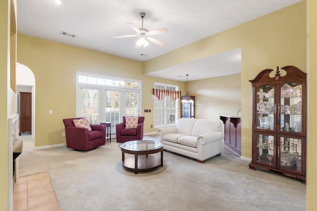 living room featuring light colored carpet and ceiling fan