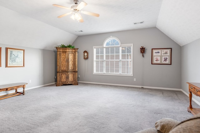 unfurnished room featuring ceiling fan, light colored carpet, and lofted ceiling