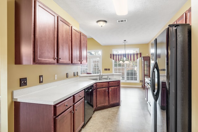 kitchen with sink, black appliances, a textured ceiling, hanging light fixtures, and a notable chandelier