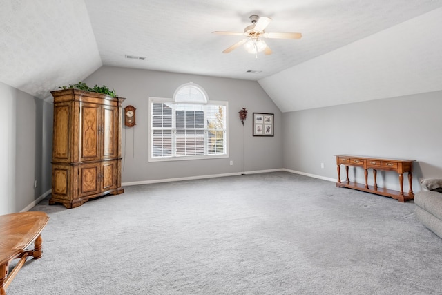 additional living space featuring lofted ceiling and light carpet