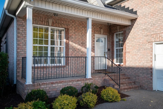 view of exterior entry with covered porch