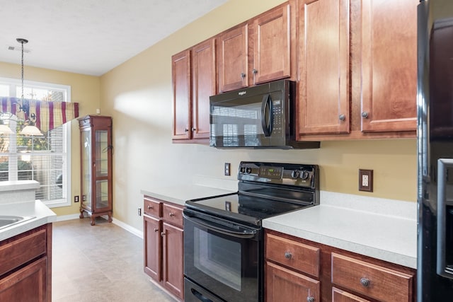 kitchen featuring an inviting chandelier, black appliances, and decorative light fixtures