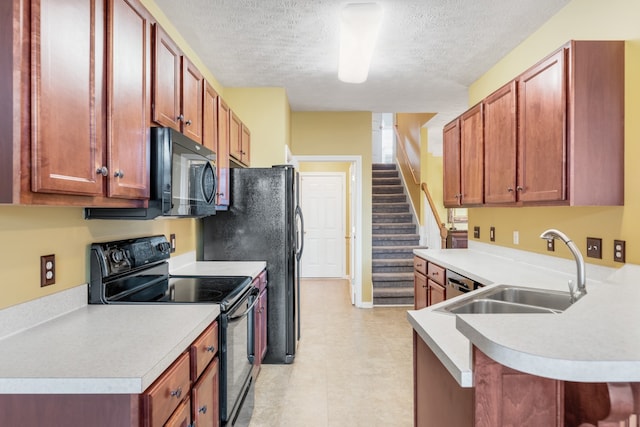 kitchen featuring black appliances, kitchen peninsula, sink, and a textured ceiling