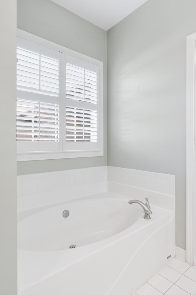 bathroom featuring a bath, tile patterned flooring, and a healthy amount of sunlight