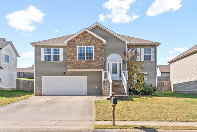 split foyer home featuring a front lawn and a garage