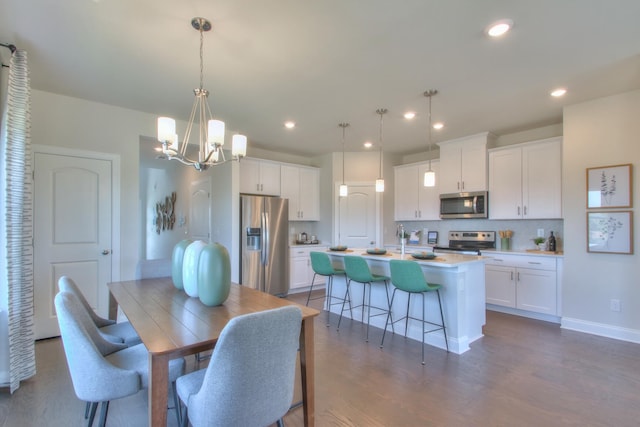 dining space featuring dark hardwood / wood-style flooring and a notable chandelier