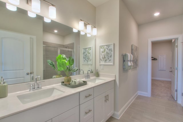 bathroom featuring vanity and a shower with door