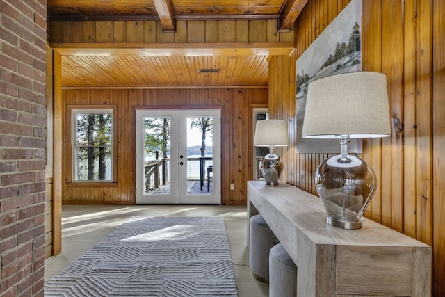 doorway with french doors, brick wall, beam ceiling, wooden ceiling, and wood walls