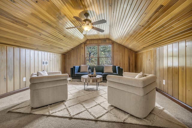 carpeted living room with ceiling fan, wood walls, wooden ceiling, and vaulted ceiling