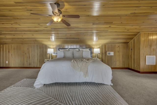 bedroom with carpet, wood ceiling, and wooden walls