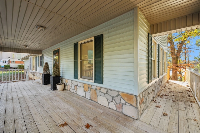 wooden terrace featuring covered porch