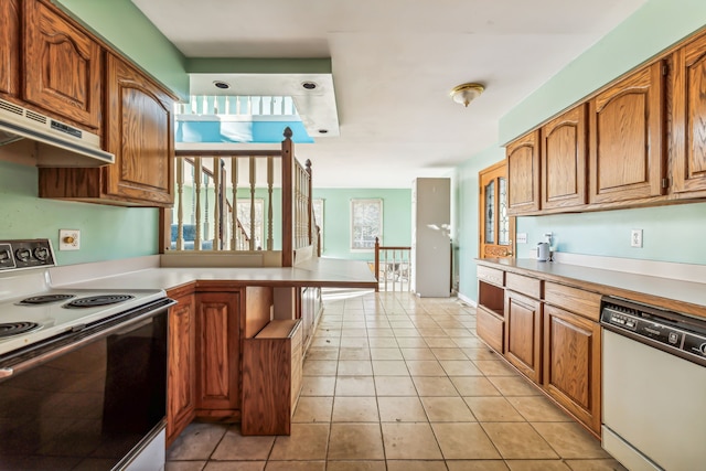 kitchen featuring white appliances and light tile patterned floors