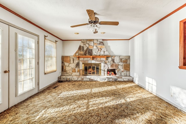 unfurnished living room featuring a stone fireplace, ornamental molding, and a textured ceiling