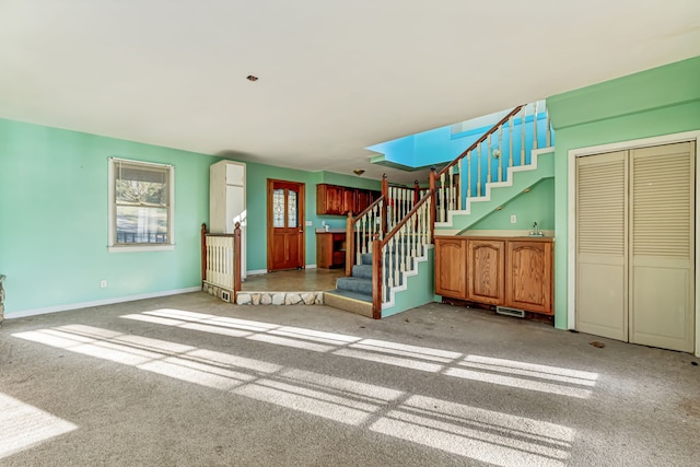 unfurnished living room featuring carpet flooring