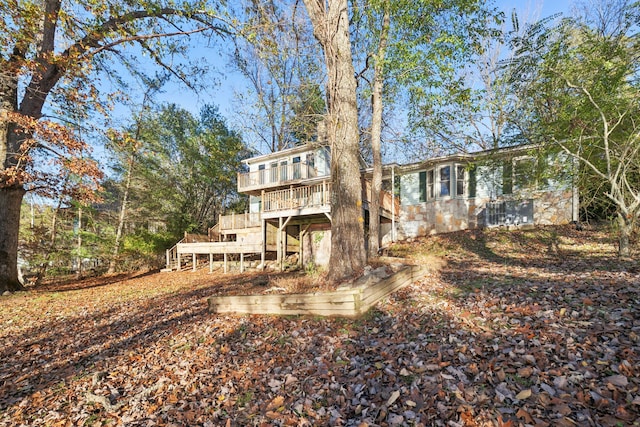 rear view of property featuring a wooden deck