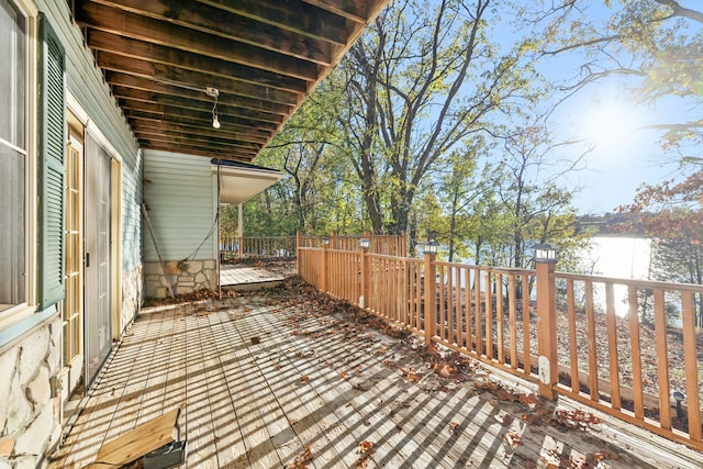 wooden deck featuring a patio area and a water view