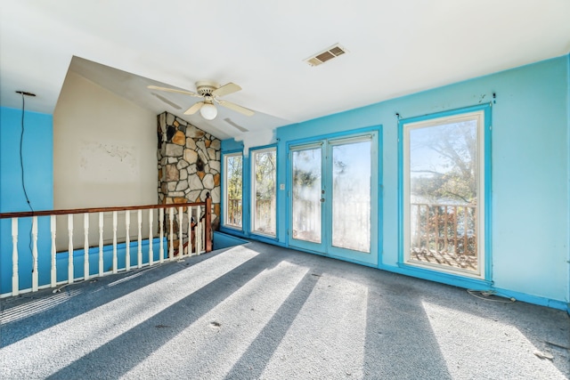 unfurnished room featuring vaulted ceiling, carpet flooring, and ceiling fan