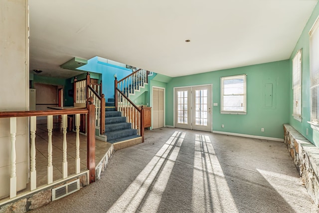 carpeted foyer entrance featuring french doors