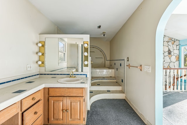 bathroom with vanity and decorative backsplash