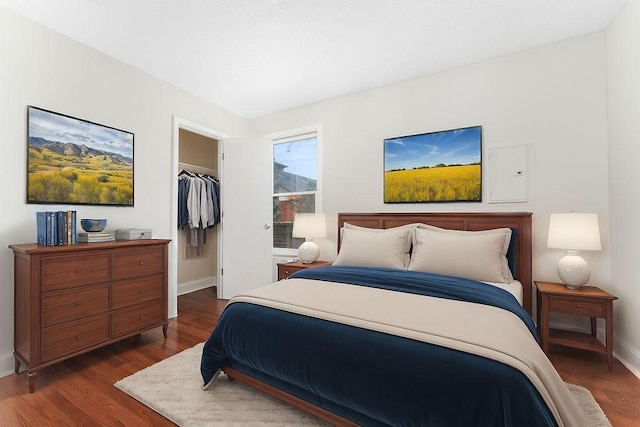 bedroom featuring dark hardwood / wood-style flooring and a closet