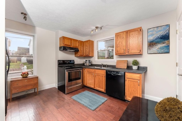 kitchen featuring dark hardwood / wood-style flooring, plenty of natural light, and appliances with stainless steel finishes