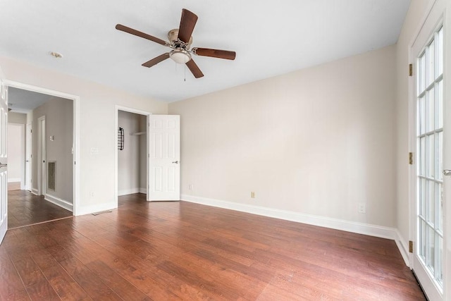 unfurnished bedroom with ceiling fan, a closet, and dark wood-type flooring