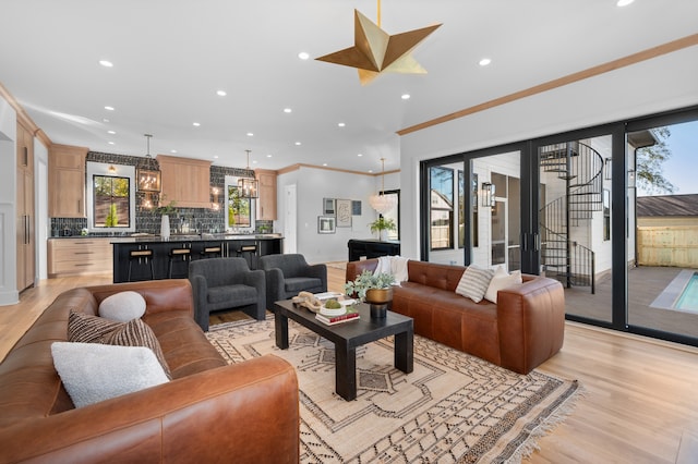 living room with ornamental molding and light wood-type flooring