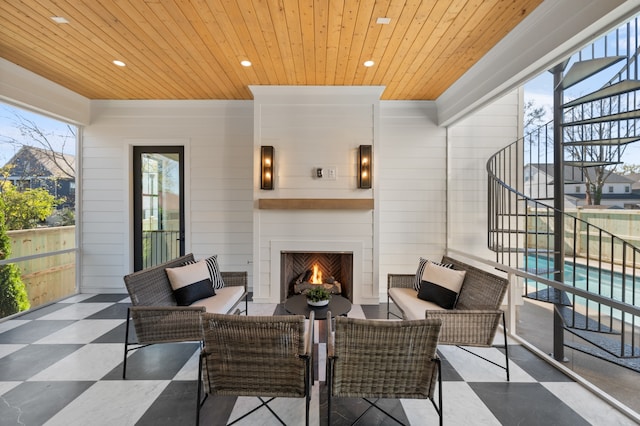 view of patio / terrace with an outdoor living space with a fireplace