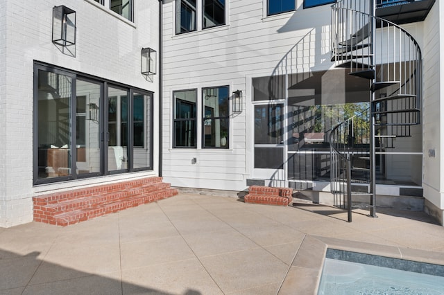 property entrance featuring a patio area