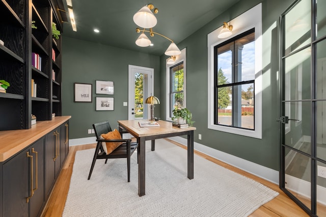 home office with light hardwood / wood-style floors