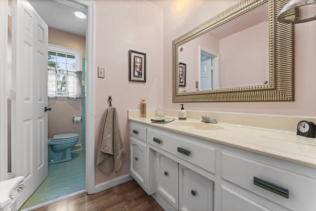 bathroom featuring hardwood / wood-style floors, vanity, and toilet