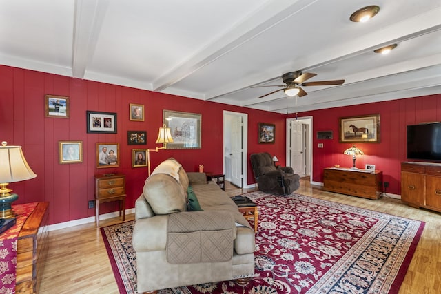 living room with beam ceiling, light hardwood / wood-style flooring, ceiling fan, and crown molding