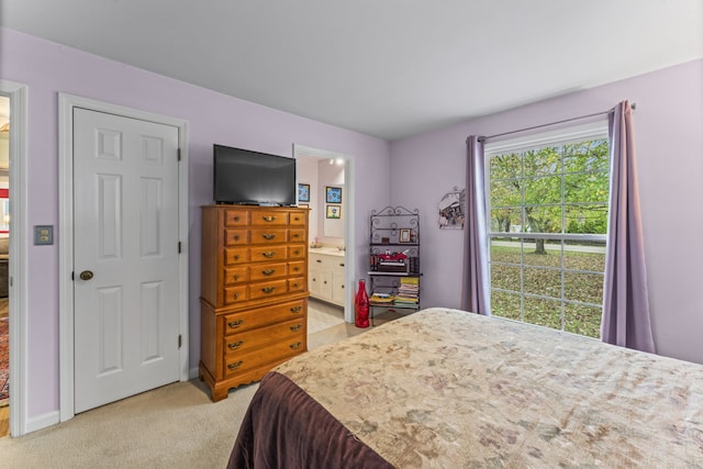 carpeted bedroom with ensuite bath