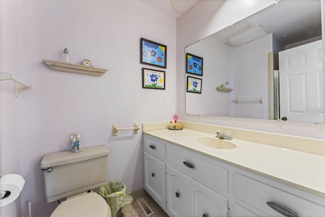 bathroom featuring tile patterned floors, vanity, and toilet