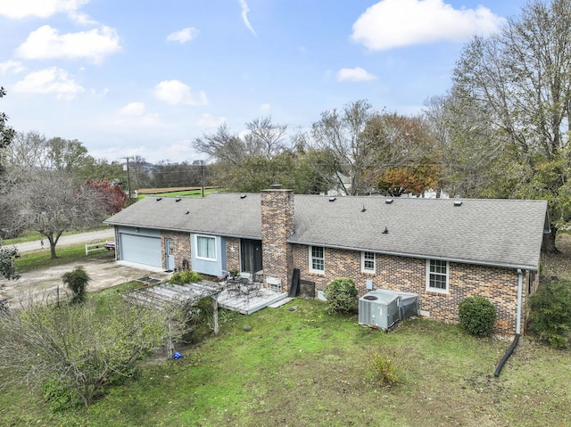 back of property featuring a yard and a garage