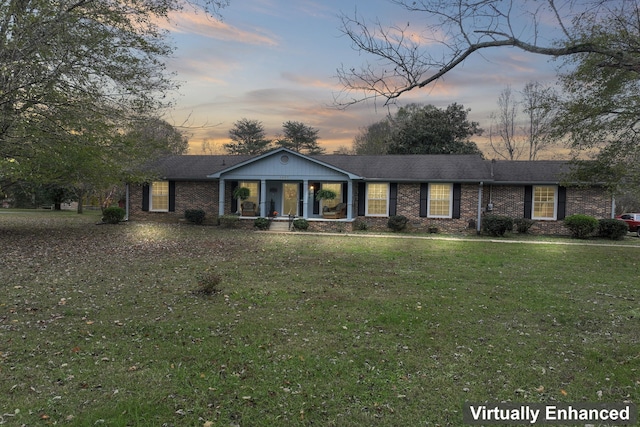 ranch-style home with a yard