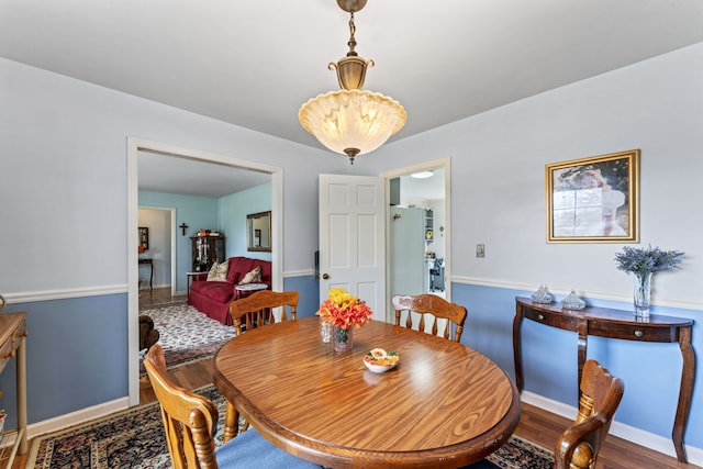 dining space with hardwood / wood-style flooring