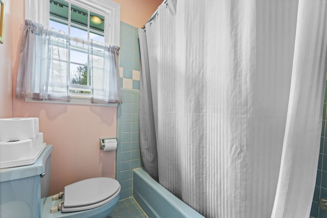 bathroom featuring tile patterned flooring, toilet, and shower / bath combo with shower curtain